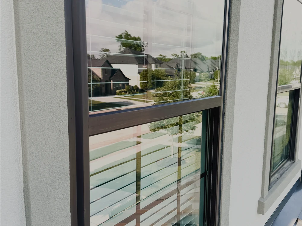A cleaned exterior window reflecting a clear sky.
